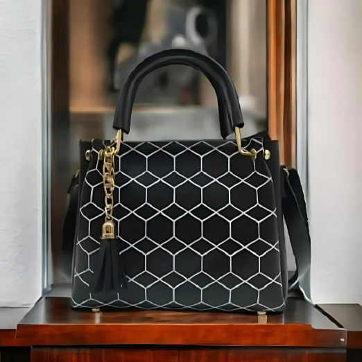 Black handbag with geometric pattern on a wooden surface