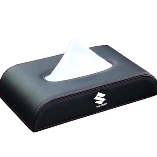 Black tissue holder with a white tissue on a white background, featuring the Suzuki logo.