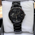 Black wristwatch with silver accents on a white textured surface