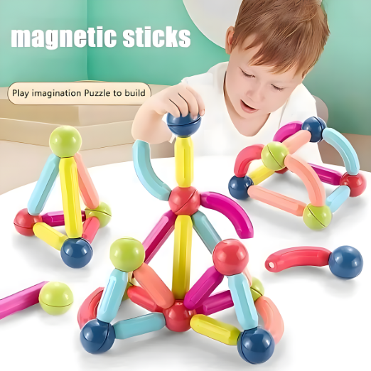 Child playing with colorful magnetic sticks on a white surface