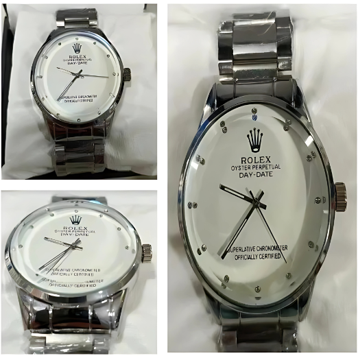 Silver wristwatch with a white face on a white fabric background
