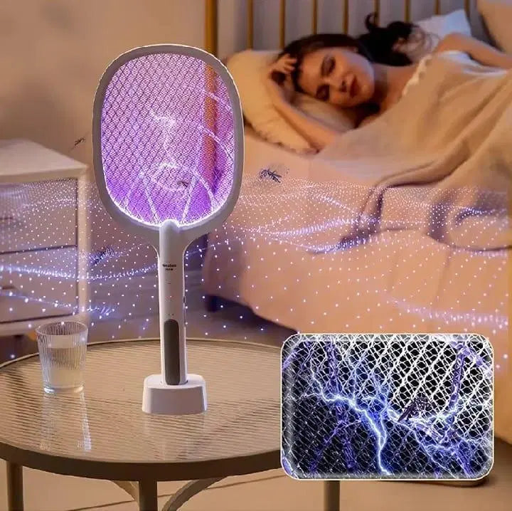 Electric fly swatter on a table with a person sleeping