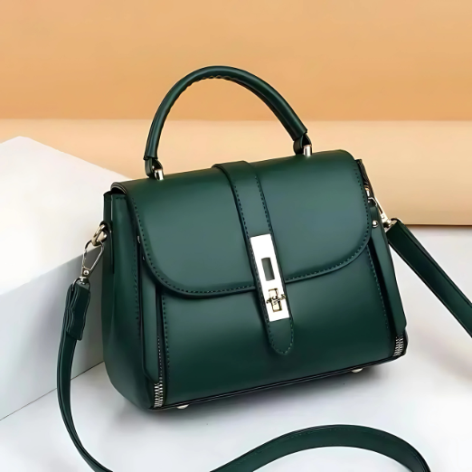 Green handbag with a strap on a white surface with a beige background