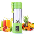 Green portable blender with fruits and drinks on a white background