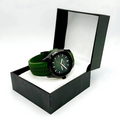 Green watch with a green strap in an open black box on a white background