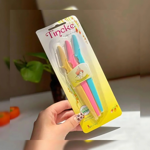 Hand holding a package of colorful toothbrushes with 'Tincke' branding.