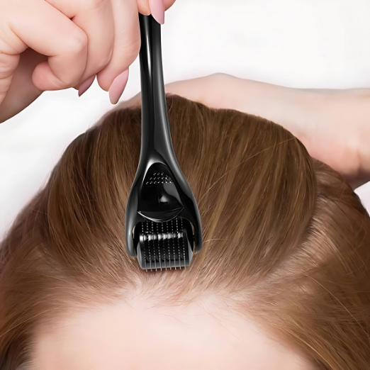 Person using a black hair follicle remover on their head against a white background with help of derma roller