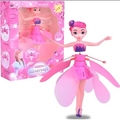 Pink fairy toy with open wings next to its packaging