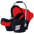 Red and black baby car seat with installation label on a white background