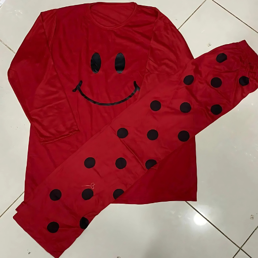 Person wearing a red outfit with a smiley face design on a beige background