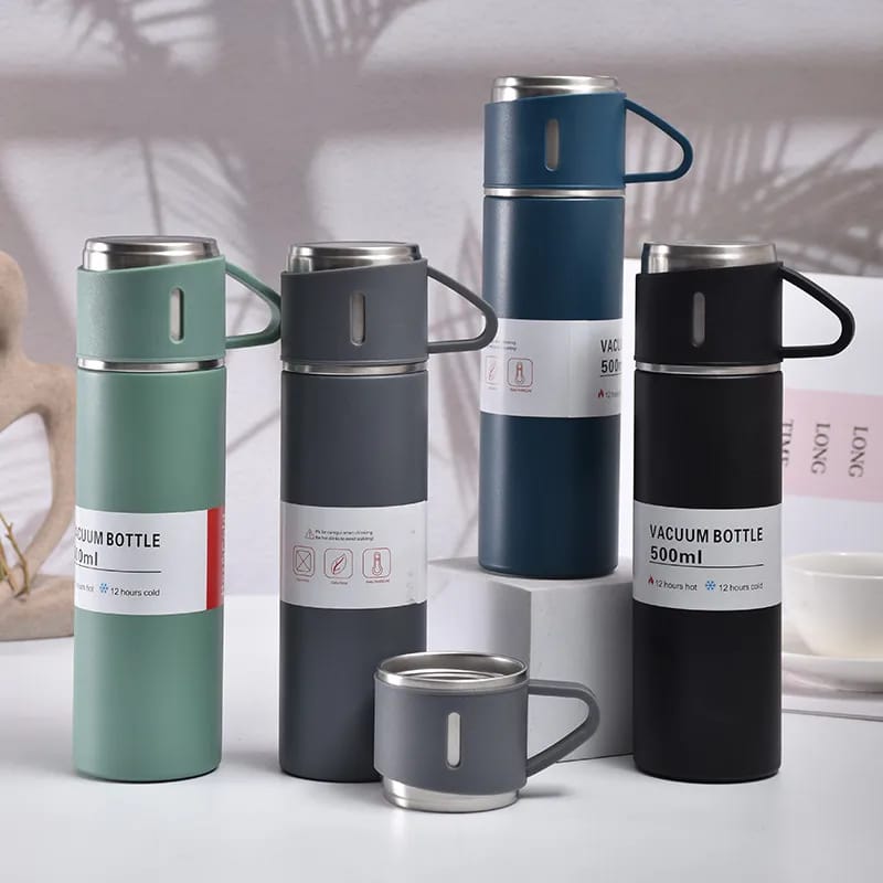 Set of vacuum bottles in various colors on a light background