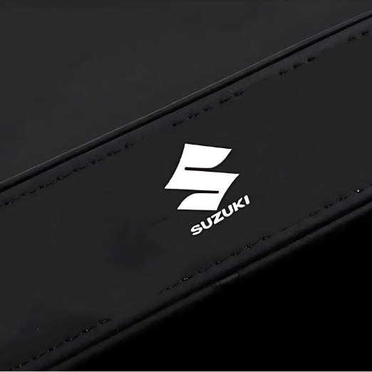 Black tissue holder with a white tissue on a white background, featuring the Suzuki logo.