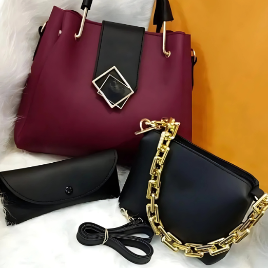 Two handbags, one maroon with a black strap and gold buckle, the other black with a gold chain strap, on a white and orange gradient background.