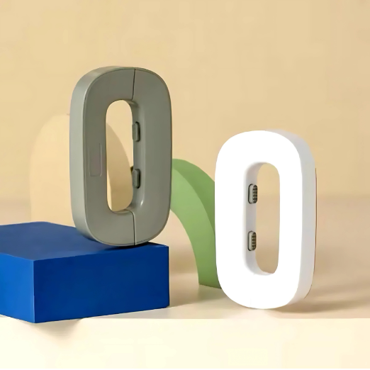 Two letter-shaped night lights, one gray and one white