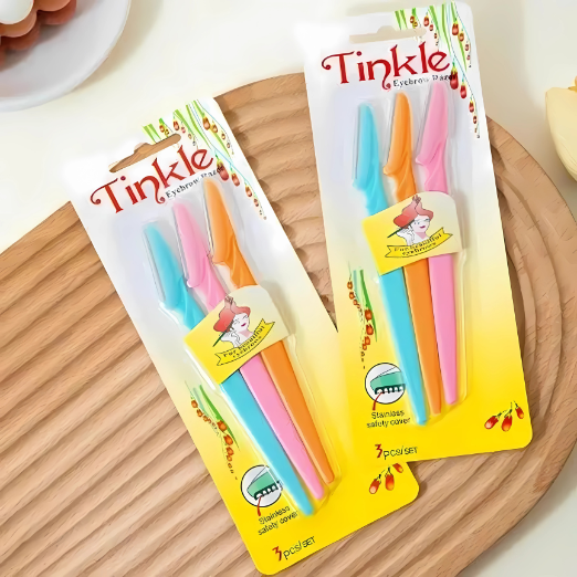 Hand holding a package of colorful toothbrushes with 'Tincke' branding.