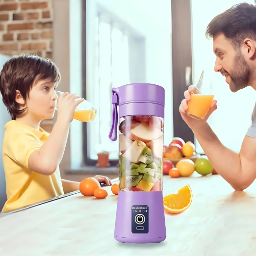 Two people drinking orange juice from a purple portable blender filled with fruits in a kitchen.
