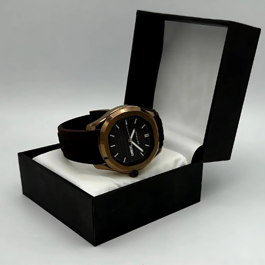 Watch with black strap and bronze case in a black box on a gray background