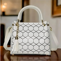 White handbag with black geometric pattern 