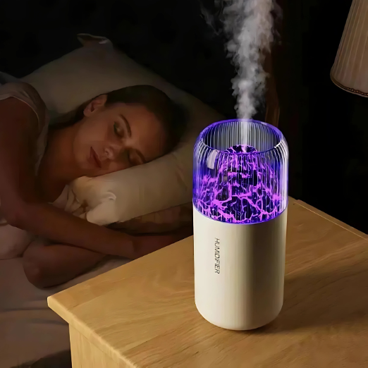 Woman lying in bed with a diffuser emitting steam on a wooden nightstand.