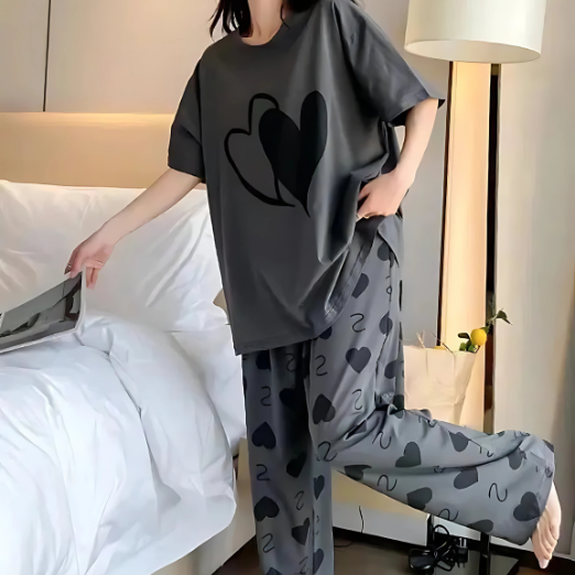 Women wearing a dark gray oversized shirt with heart patterns