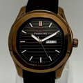 Watch with bronze case and black strap on a gray background